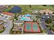 Aerial view of community amenities including tennis courts, playground, pool with slides and golf course at 3038 Camden Way, Davenport, FL 33837
