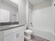 Bathroom featuring shower-tub combo and modern vanity with cabinets and a large mirror at 3038 Camden Way, Davenport, FL 33837