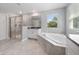 Bright bathroom featuring walk-in shower, soaking tub, and double sink vanities at 3038 Camden Way, Davenport, FL 33837