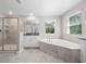 Bathroom featuring a stand-up shower, soaking tub, and a single vanity at 3038 Camden Way, Davenport, FL 33837