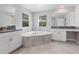 Bathroom featuring vanity with double sinks, soaking tub, and large mirrors at 3038 Camden Way, Davenport, FL 33837