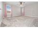 Comfortable bedroom with plush carpeting, ceiling fan, and stylish curtains framing the bright windows at 3038 Camden Way, Davenport, FL 33837