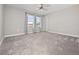 Inviting bedroom with plush carpeting, ceiling fan, and bright windows framed by stylish curtains at 3038 Camden Way, Davenport, FL 33837