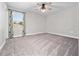 Bright bedroom with soft carpeting, a ceiling fan, and a large window providing ample natural light at 3038 Camden Way, Davenport, FL 33837