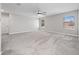 Spacious bedroom boasts soft carpeting, a ceiling fan, and natural light from two windows at 3038 Camden Way, Davenport, FL 33837