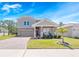 Charming two-story home with a manicured lawn, paved driveway, and neutral-toned facade, plus a two-car garage at 3038 Camden Way, Davenport, FL 33837