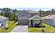 Charming two-story home with a well-manicured lawn and a welcoming covered front porch at 3038 Camden Way, Davenport, FL 33837