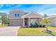 Beautiful two-story home with a well-kept lawn and welcoming covered front porch at 3038 Camden Way, Davenport, FL 33837