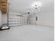 Spacious, clean garage with modern lighting, ample storage space, and painted floors at 3038 Camden Way, Davenport, FL 33837