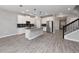 Modern open-concept kitchen featuring stainless steel appliances, white cabinets, gray countertops, and tile floors at 3038 Camden Way, Davenport, FL 33837