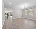 Open concept living room with tile floors, natural light, and modern fixtures at 3038 Camden Way, Davenport, FL 33837