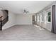 Open living room with tile floors, ceiling fan, staircase and lots of natural light at 3038 Camden Way, Davenport, FL 33837