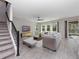 Bright living room with neutral walls, ceiling fan, tile floors, and large windows letting in natural light at 3038 Camden Way, Davenport, FL 33837
