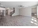 Open concept living area with staircase, tile flooring, and view into dining area at 3038 Camden Way, Davenport, FL 33837