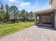 Screened in back patio with brick pavers overlooking fenced yard and wooded area at 3038 Camden Way, Davenport, FL 33837