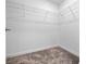 A walk-in closet offers a neutral color palette, carpet, and plenty of storage with wire shelving at 3038 Camden Way, Davenport, FL 33837