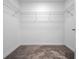 Spacious walk-in closet features wire shelving and neutral carpeting for optimal storage solutions at 3038 Camden Way, Davenport, FL 33837