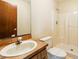 Bright bathroom featuring a shower and a vanity with a wooden countertop at 3075 Simpson Rd, Kissimmee, FL 34744