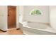 Bathroom showcases a soaking tub with an arched window, and a separate shower with copper fixtures at 3075 Simpson Rd, Kissimmee, FL 34744