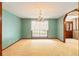 Spacious dining room with large window, chandelier, and neutral color palette at 3075 Simpson Rd, Kissimmee, FL 34744
