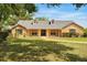 Charming single-story home boasts a manicured lawn and traditional brick and siding exterior at 3075 Simpson Rd, Kissimmee, FL 34744