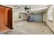 Spacious garage with a ceiling fan and natural light from the windows at 3075 Simpson Rd, Kissimmee, FL 34744