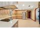 Bright kitchen featuring wood cabinets, stainless steel appliances and tile backsplash with eat-in counter at 3075 Simpson Rd, Kissimmee, FL 34744