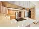 Bright kitchen featuring wood cabinets, stainless steel appliances, tile backsplash and large island cooktop at 3075 Simpson Rd, Kissimmee, FL 34744