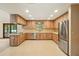 Bright kitchen featuring wood cabinets, stainless steel appliances and tile backsplash with view to Gathering room at 3075 Simpson Rd, Kissimmee, FL 34744