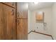 Laundry room with built in wood cabinets and tile flooring, and hook ups for a washer and dryer at 3075 Simpson Rd, Kissimmee, FL 34744