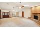 Large open living area with brick fireplace, large wooden door, and light neutral colors at 3075 Simpson Rd, Kissimmee, FL 34744