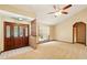 Living area with striking wooden doors, brick accent wall, and neutral color scheme at 3075 Simpson Rd, Kissimmee, FL 34744