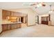 Open concept living room with wooden kitchen area, skylights, and stylish wooden doors at 3075 Simpson Rd, Kissimmee, FL 34744