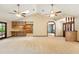Expansive living room featuring wood kitchen area, skylights, and stylish archways and wooden doors at 3075 Simpson Rd, Kissimmee, FL 34744