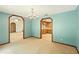 Open living room with chandelier and view to dining room and kitchen at 3075 Simpson Rd, Kissimmee, FL 34744