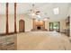 Spacious living room with vaulted ceilings, brick fireplace, skylights, ceiling fans, and access to backyard at 3075 Simpson Rd, Kissimmee, FL 34744