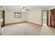 Spacious bedroom with fan, neutral color palette and view to ensuite bath at 3075 Simpson Rd, Kissimmee, FL 34744