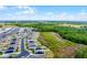 Extensive aerial shot of a residential street lined with modern homes and solar panels in a naturally green neighborhood at 3161 Royal Tern Dr, Winter Haven, FL 33881