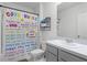 Bathroom with a toilet, sink with vanity, shower curtain, and bright overhead lighting at 3161 Royal Tern Dr, Winter Haven, FL 33881