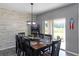 Elegant dining room with a modern chandelier, a large table with seating, and sliding glass doors to the patio at 3161 Royal Tern Dr, Winter Haven, FL 33881