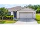 Charming single-story home featuring a two-car garage and a well-maintained front yard with lush landscaping at 3161 Royal Tern Dr, Winter Haven, FL 33881