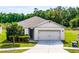 Inviting single-story home with a neutral color scheme, two-car garage, and a well-manicured lawn at 3161 Royal Tern Dr, Winter Haven, FL 33881