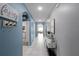 Welcoming hallway featuring arched doorways, neutral paint, tiled floors, and stylish decor at 3161 Royal Tern Dr, Winter Haven, FL 33881