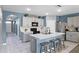 Spacious kitchen with an island, gray cabinets, stainless steel appliances, and modern lighting at 3161 Royal Tern Dr, Winter Haven, FL 33881