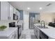Well-equipped kitchen with gray cabinets, stainless steel appliances, ample counter space, and modern finishes at 3161 Royal Tern Dr, Winter Haven, FL 33881