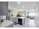 Open-concept kitchen featuring stainless steel appliances, an island, and a view of the dining and living areas at 3161 Royal Tern Dr, Winter Haven, FL 33881