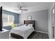 Cozy main bedroom with gray walls, plush bed, ceiling fan and a window bringing in lots of natural light at 3161 Royal Tern Dr, Winter Haven, FL 33881