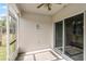 Enclosed patio featuring a ceiling fan, neutral rug, and sliding glass doors to interior living space at 3161 Royal Tern Dr, Winter Haven, FL 33881