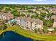 Picturesque aerial view of waterfront townhomes and pool in a lush setting at 3344 Corona Village Way # 308, Orlando, FL 32835