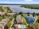 Scenic aerial view of townhomes with a lake and pool in a lush community at 3344 Corona Village Way # 308, Orlando, FL 32835
